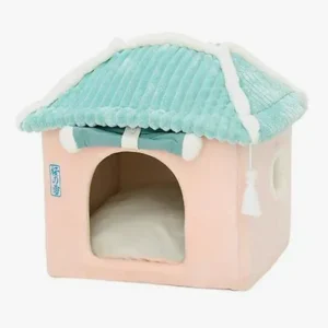 Maison douillette pour petits animaux en rose pastel et teal, parfaite pour le confort.