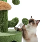 Un chat siamois joue avec un arbre à chats coloré en forme de cactus.