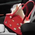 Petit chien blanc dans un sac rouge en caoutchouc écologique